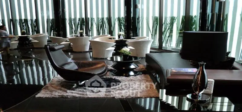 Luxurious modern lobby with sleek furniture and floor-to-ceiling windows.