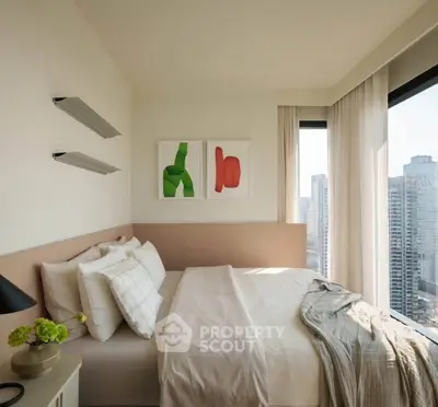 Modern bedroom with city view, featuring stylish decor and large windows for natural light.