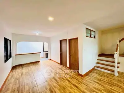 Spacious living room with wooden flooring and staircase in modern home