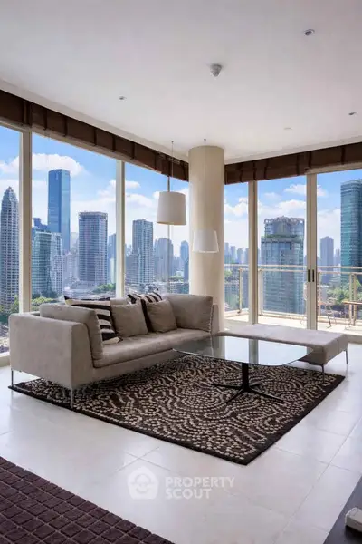 Luxurious living room with panoramic city skyline views and modern furnishings.