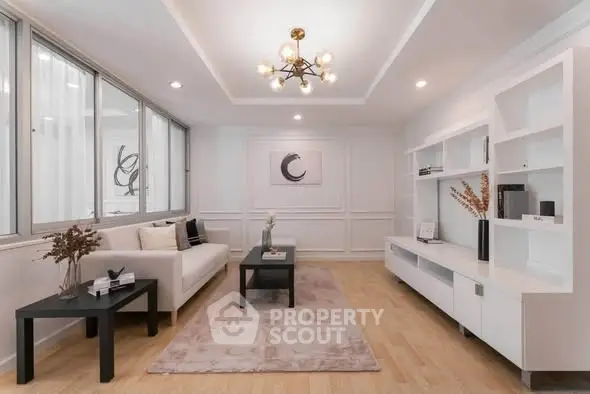 Elegant modern living room with stylish decor and ample natural light