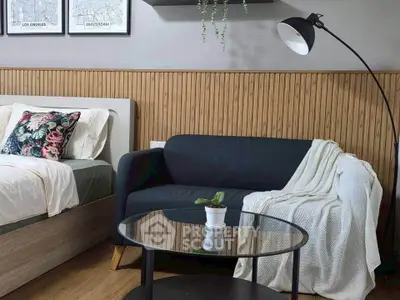 Stylish bedroom with cozy sofa and modern decor, perfect for relaxation and comfort.
