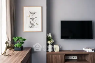 Modern living room with stylish decor, wall-mounted TV, and elegant wooden furniture.