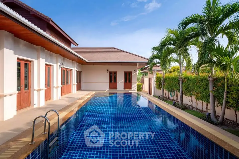 Luxurious villa with private pool and lush garden in tropical paradise.