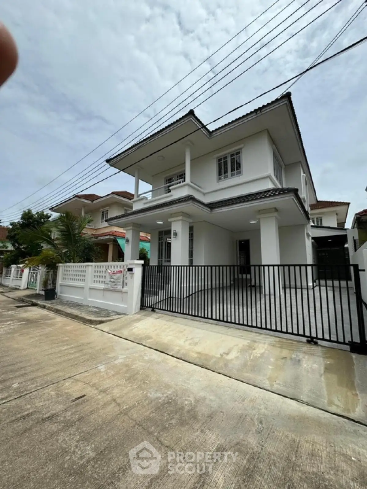 Charming two-story house with modern design and spacious driveway in a serene neighborhood.