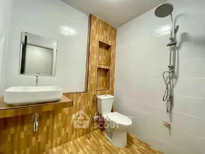 Modern bathroom with wooden accents and sleek fixtures