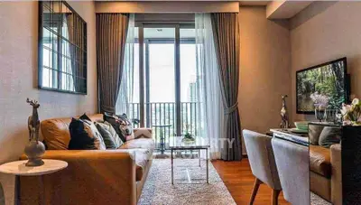 Stylish living room with modern decor and balcony view in urban apartment.