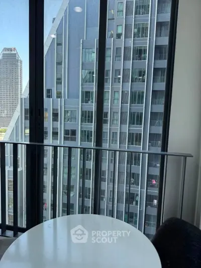 Modern high-rise apartment view with sleek balcony and cityscape backdrop.