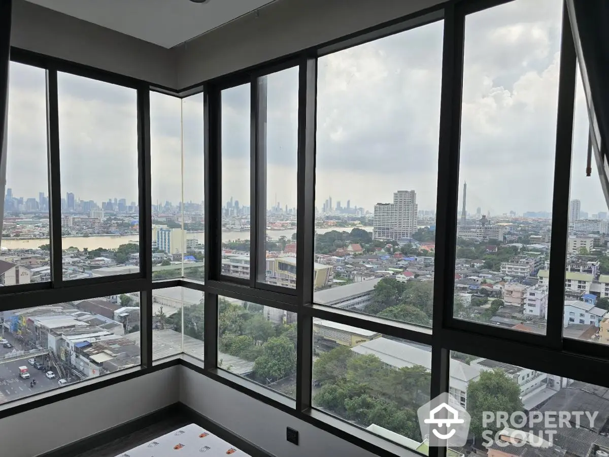 Stunning panoramic city view from high-rise corner unit with large windows.