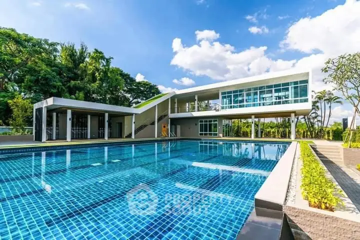 Luxurious modern building with stunning outdoor pool and lush greenery.
