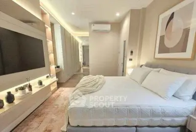 Luxurious modern bedroom with stylish decor and ample natural light