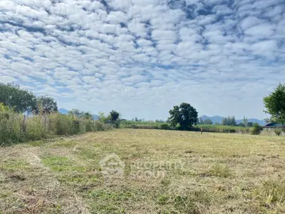 Expansive plot of land with scenic mountain views and open sky, perfect for development.