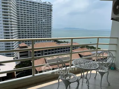 Stunning ocean view from a high-rise balcony with elegant outdoor seating.