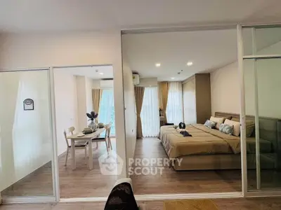 Modern open-plan bedroom and dining area with elegant decor and natural light.