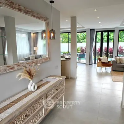 Luxurious open-plan living room with elegant decor and garden view, perfect for modern living.