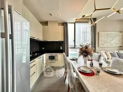 Modern open-layout kitchen and dining area with elegant decor and natural light.