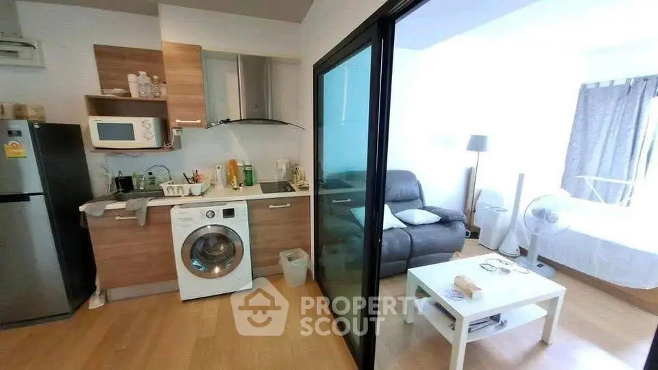 Modern studio apartment with compact kitchen and cozy living area