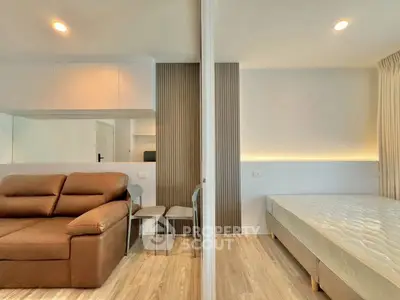 Modern studio apartment with cozy living area and comfortable bed