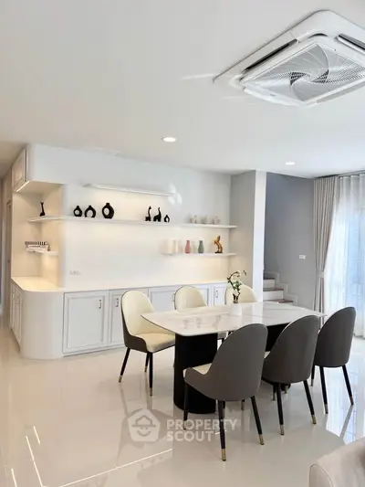Elegant dining area with modern decor and sleek furniture in a stylish open-plan living space.