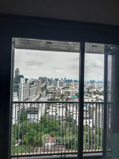 Stunning cityscape view from high-rise balcony with expansive skyline and lush greenery.