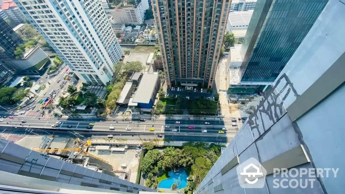 Stunning high-rise cityscape view from a skyscraper, showcasing urban architecture and vibrant city life.