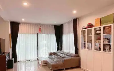 Spacious living room with modern decor and large windows for natural light.