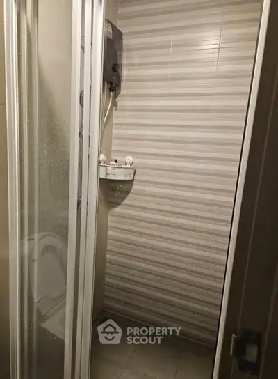 Compact bathroom with shower enclosure and modern water heater