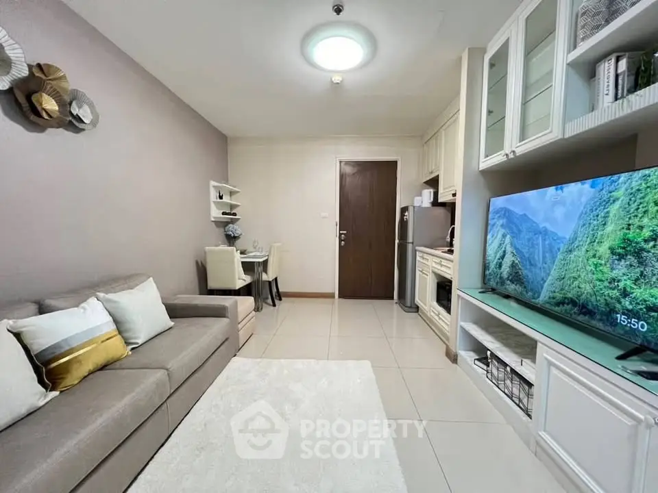 Modern living room with cozy sofa, dining area, and sleek kitchen in open layout.