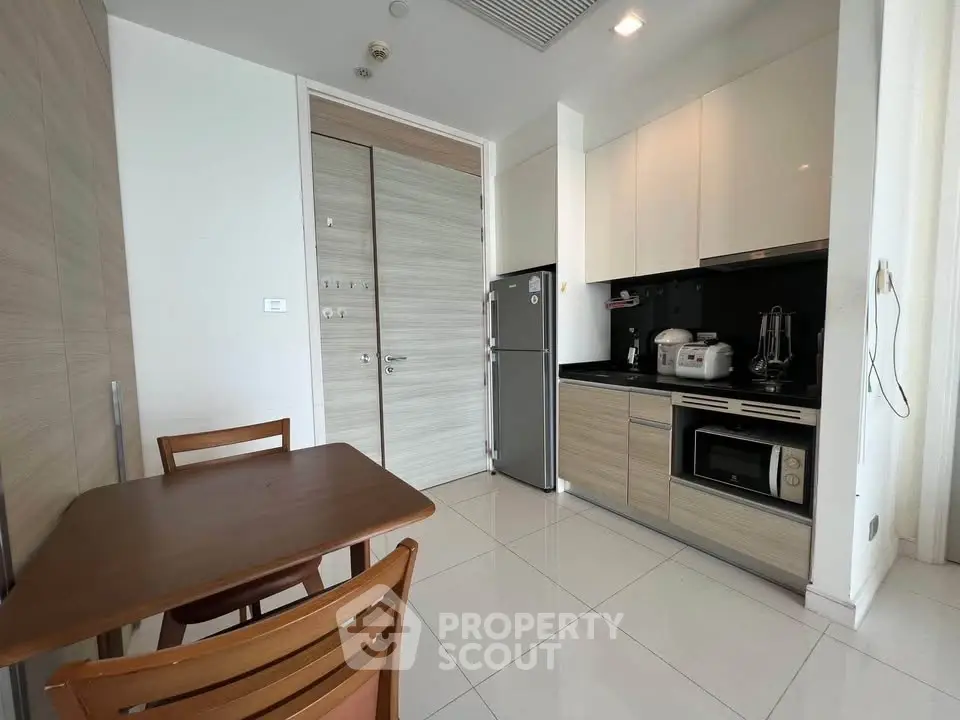 Modern kitchen with sleek cabinets and dining area in a stylish apartment