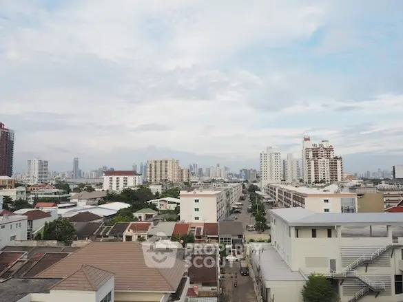 Stunning cityscape view showcasing urban skyline and residential buildings under a clear sky.