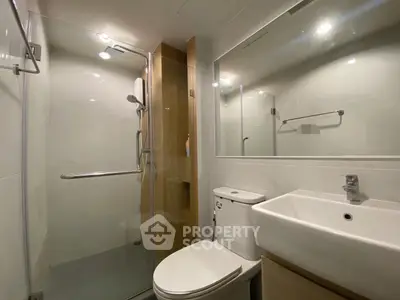 Modern bathroom with glass shower and sleek fixtures