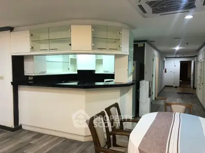 Spacious open-layout kitchen with dining area in modern apartment