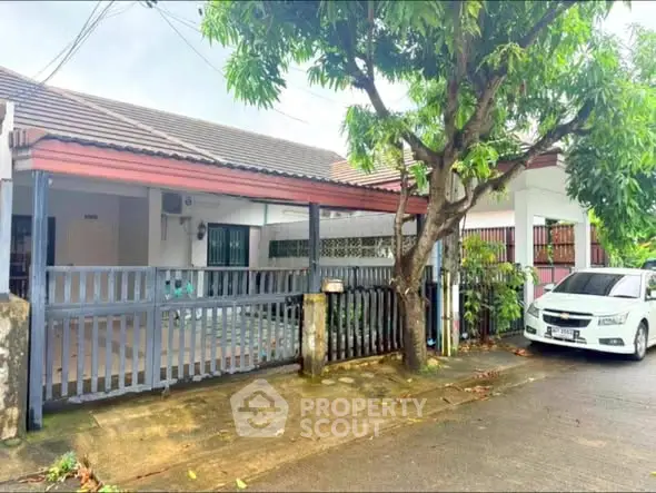Charming suburban home with carport and lush greenery, perfect for family living.