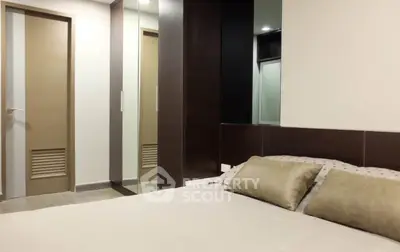 Modern bedroom with sleek design and mirrored closet doors