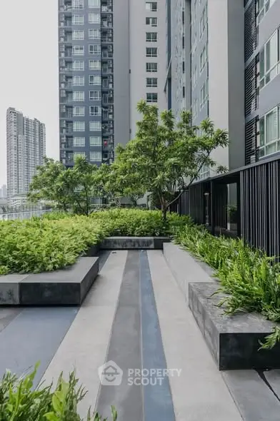Modern urban garden with lush greenery and high-rise buildings