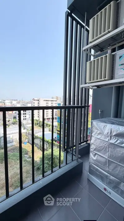 Modern balcony with city view and air conditioning units, perfect for urban living.