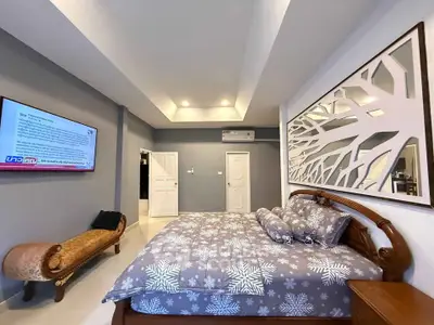 Spacious bedroom with elegant decor and modern amenities in a luxurious real estate property.