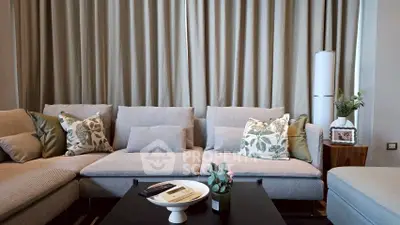 Stylish living room with modern sofa and decorative pillows, perfect for relaxation and entertaining.