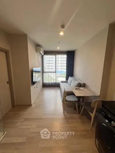 Modern living room with natural light and stylish furniture in a cozy apartment.