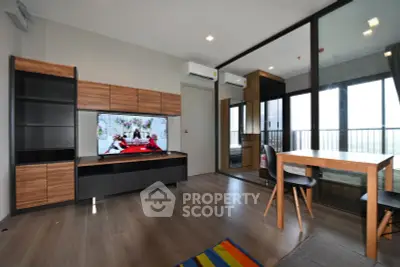 Modern living room with sleek furniture and balcony view in a stylish apartment.