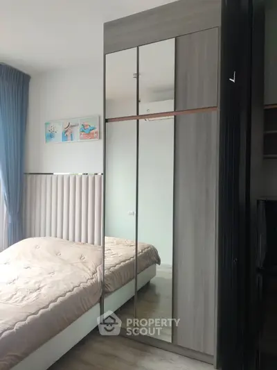 Modern bedroom with mirrored wardrobe and cozy bed setup