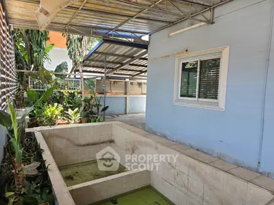 Spacious outdoor area with tiled pool and garden, perfect for relaxation and entertainment.