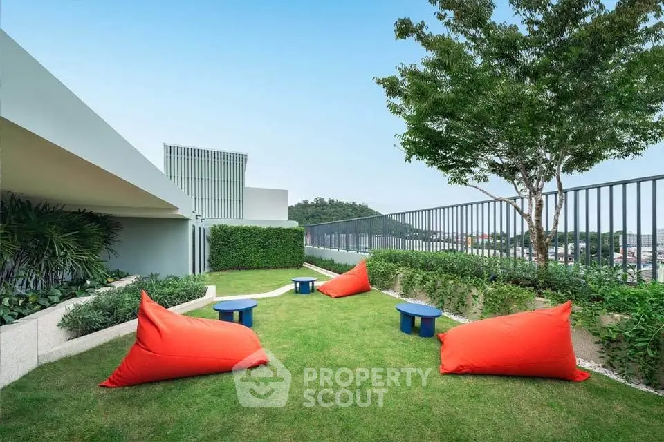 Stunning rooftop garden with vibrant seating and lush greenery, perfect for relaxation and city views.