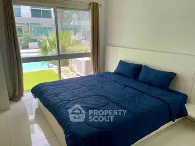 Spacious bedroom with pool view and modern decor