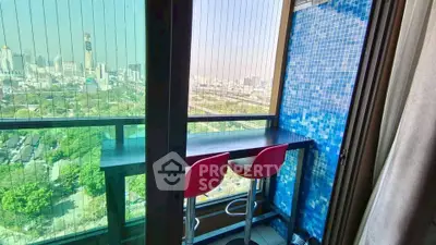 Chic urban balcony with stunning city view and modern seating area.