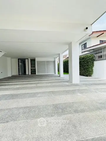 Spacious modern parking area with sleek design and ample space in a contemporary residential property.