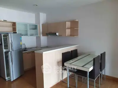 Modern kitchen with sleek cabinetry and dining area in open layout