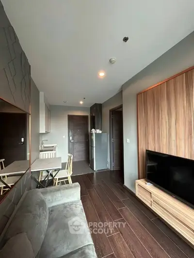 Modern living room with sleek wooden flooring and stylish furniture