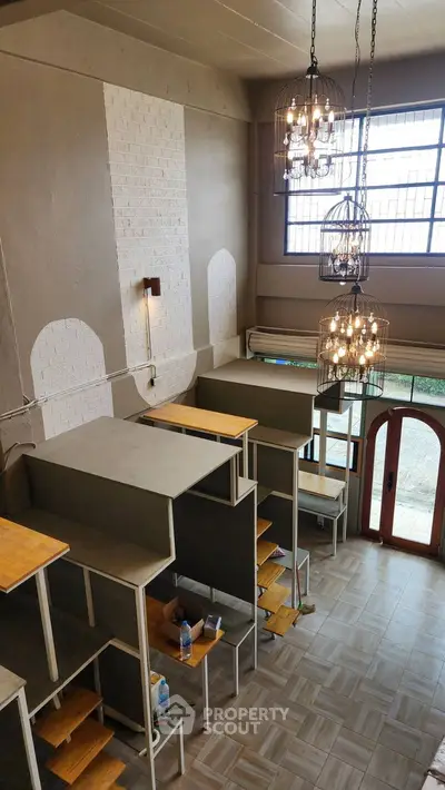 Spacious loft-style interior with high ceilings and modern lighting fixtures.