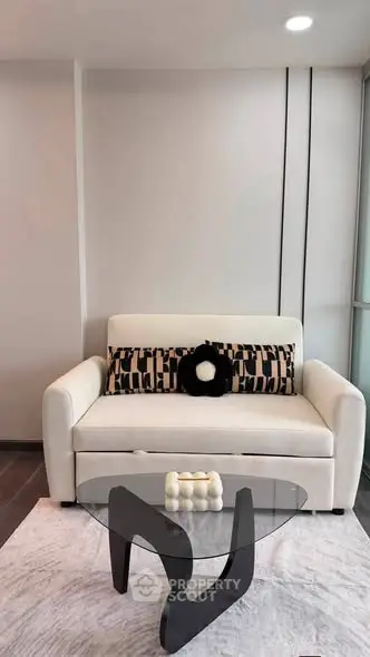 Modern living room with stylish sofa and unique glass coffee table